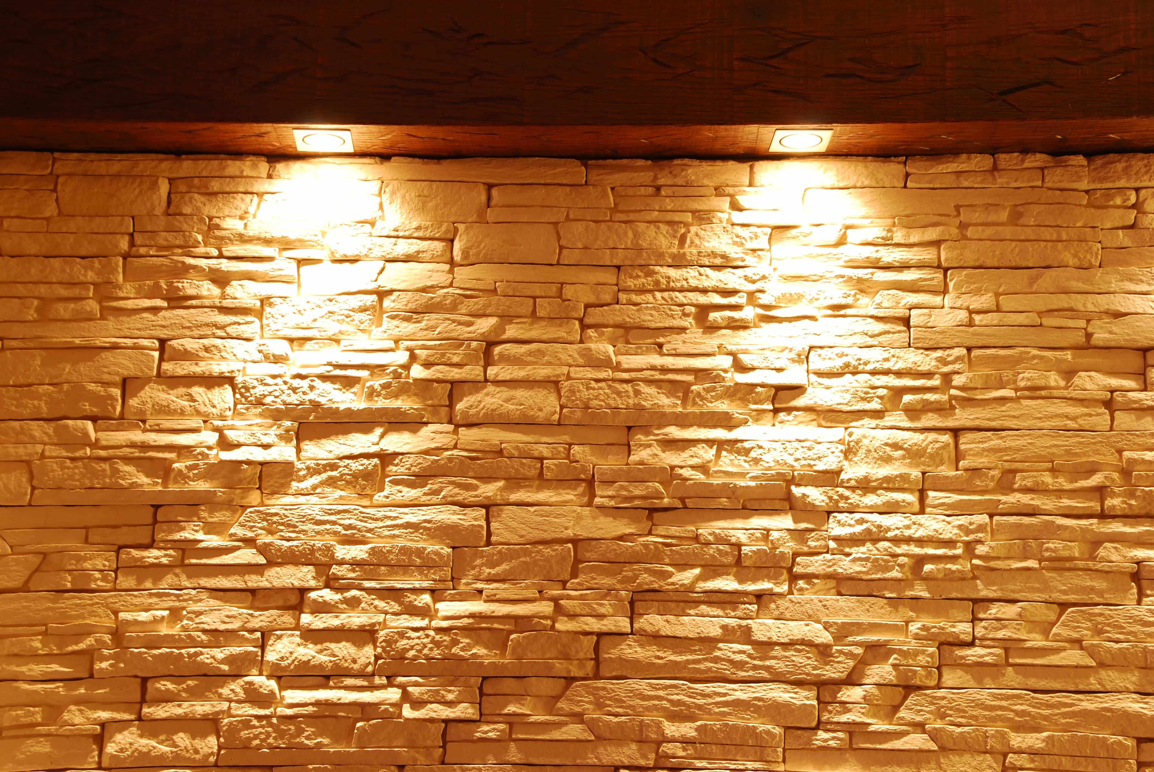 Unshaped stone wall with spot lights Home Staging Solutions